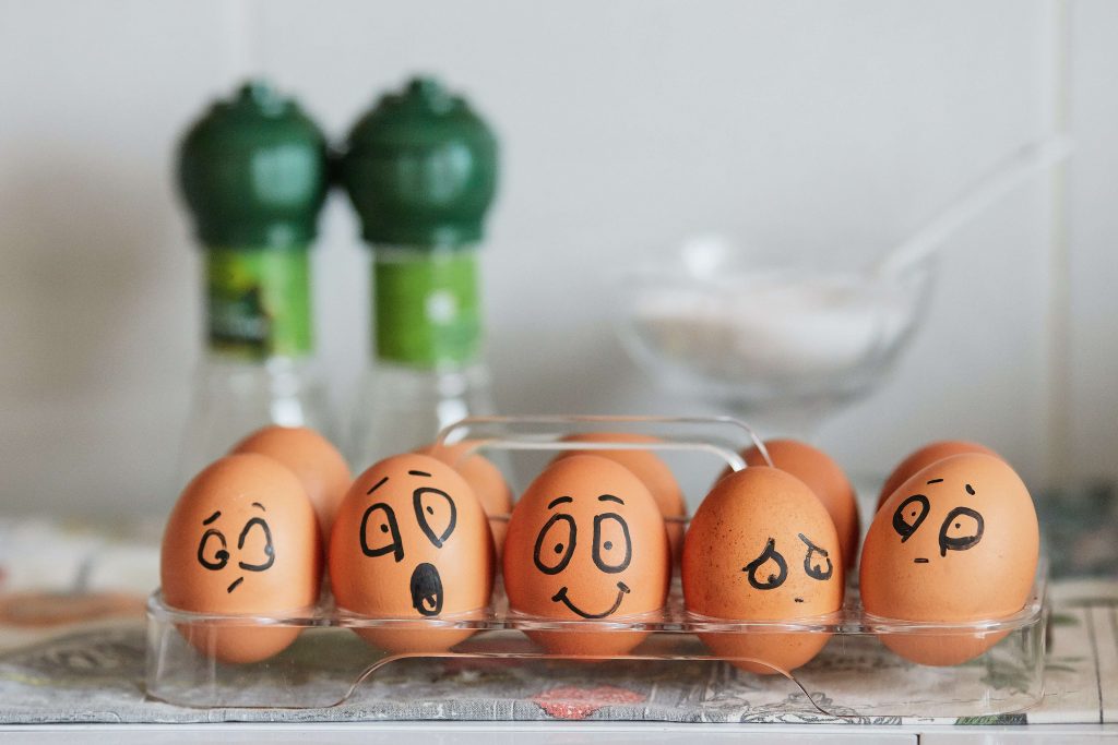eggs with different facial expressions painted on them