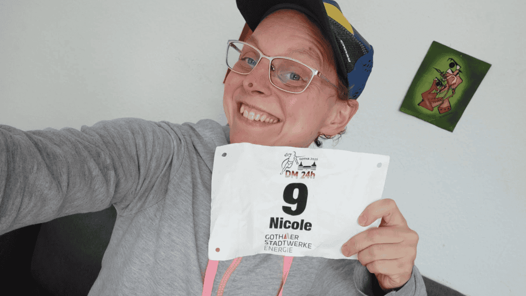 Woman holding race bib with start number 9