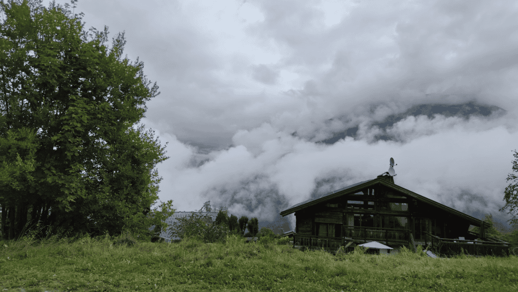 clouds over house in the Alps