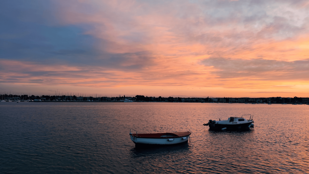 boats in the port of Umag during sunrise